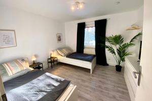 um quarto com uma cama e uma janela com uma planta em Work & stay apartment in Neuss em Neuss