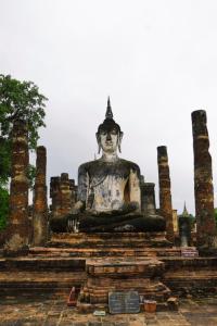 a large statue sitting on top of steps at Toon guesthouse in Sukhothai