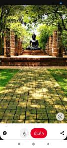 a picture of a statue in a park at Toon guesthouse in Sukhothai