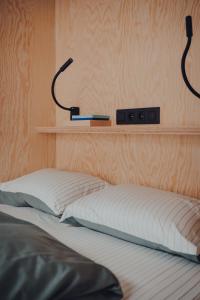 a bedroom with a bed with two controllers on the wall at Les 3 Cabanes Urbaines - centre historique in Namur