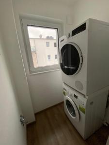 a microwave sitting in a room with a window at Hideaway Lounge Sure in Echternacherbrück