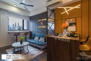 a bar in a salon with a blue chair and a table at Chambers Kuala Lumpur by Five Senses in Kuala Lumpur