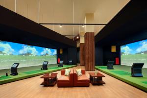 a living room with a couch and tables and large windows at The Ritz-Carlton Jakarta, Mega Kuningan in Jakarta