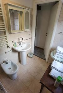 a bathroom with a sink and a toilet and a mirror at Palazzo Eugenia - Minelli in Venice +33 photos