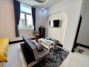 a living room with a couch and a table at Queen Sea Hotel in Phan Thiet