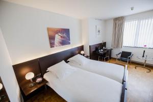 Postel nebo postele na pokoji v ubytování Hotel Verlooy