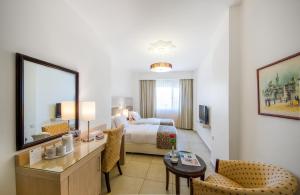 Posteľ alebo postele v izbe v ubytovaní Toledo Amman Hotel