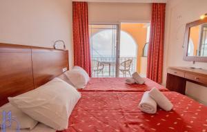 a bedroom with a bed with two towels on it at Lido Sofia Apartments in Agios Gordios