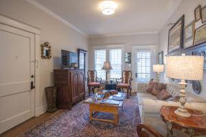 a living room with a couch and a table at Classic Central Gardens Flat in Memphis