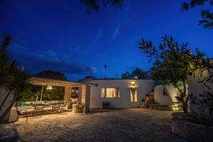 a villa with a patio at night at Trullo Limone in Ostuni