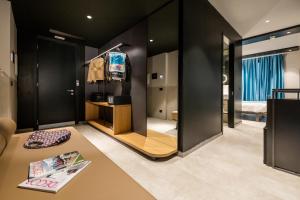 a room with a bedroom with black walls at Smart Hotel Central in Milan
