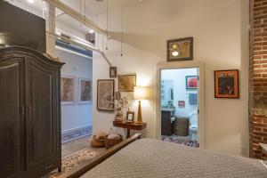 a bedroom with a bed and a door to a bathroom at Elegant Downtown Memphis Loft - Walk to Beale St! in Memphis