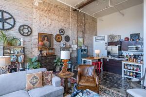 a living room with a couch and a table at Elegant Downtown Memphis Loft - Walk to Beale St! in Memphis