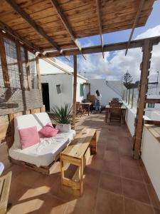 a living room with a couch and a table on a patio at BackpackerRoom's in La Santa