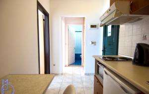 a kitchen with a door leading to a hallway at Lido Sofia Apartments in Agios Gordios