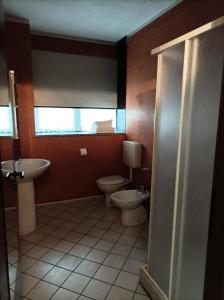 a bathroom with a toilet and a sink at Residence Le Arcate in Gavirate