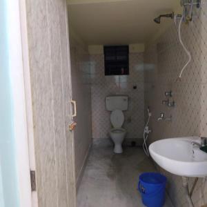 a bathroom with a toilet and a sink at Sweet home in Kolkata