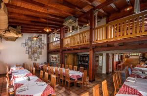 a restaurant with tables and chairs and a staircase at 5 Sunca in Kašina
