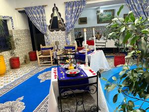 a dining room with a blue and white table with food on it at Riad Lazord De Marrakech Entier in Marrakesh