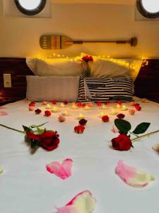 a bed with flowers on it with lights on it at La cabine du Marinier in Toulouse