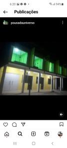 a picture of a building with green lights at Pousada universso paralello pratigi in Ituberá