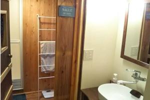 a bathroom with a sink and a towel rack at Private & Cozy Lodge - basecamp Imari in Imari