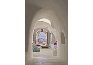 A bed or beds in a room at Perivolas Hotel