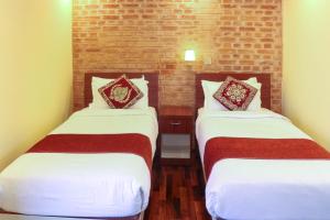 Postel nebo postele na pokoji v ubytování Budhanilkantha Sacred Trails Kathmandu Homestay