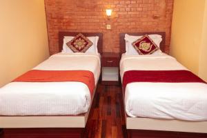 Postel nebo postele na pokoji v ubytování Budhanilkantha Sacred Trails Kathmandu Homestay