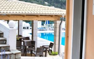 a view of a pool from the balcony of a resort at Lido Sofia Apartments in Agios Gordios