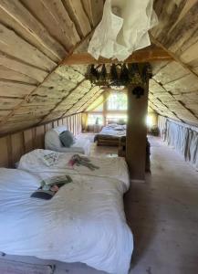 a bedroom with two beds in a large tent at Viesu Nams “Noras” in Ķesterciems