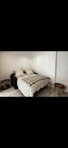 a bedroom with a bed and a table at Studio - Spacious and well equipped in Viroflay