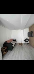 a room with a bed and two tables in it at Studio - Spacious and well equipped in Viroflay