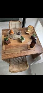 a wooden table with bread and a plate of food on it at Studio - Spacious and well equipped in Viroflay