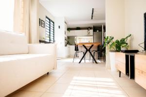 a living room with a couch and a table at Votre oasis de tranquillité proche de la ville T2 entièrement rénové et équipé secteur centre in Fort-de-France