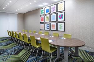 a conference room with a long table and yellow chairs at Holiday Inn Express & Suites - Colorado Springs South I-25, an IHG Hotel in Colorado Springs
