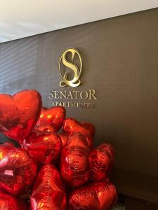 a pile of red hearts in front of a sign at Senator City Center in Kyiv