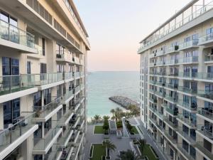 a view of the ocean from between two buildings at Blue Collection Holiday Homes - Pacific Al Marjan Island in Ras al Khaimah