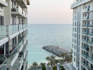 a view of the ocean from between two buildings at Blue Collection Holiday Homes - Pacific Al Marjan Island in Ras al Khaimah