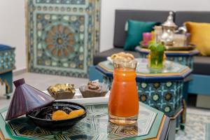a table with a drink and a bowl of food at Liberté Hotels Oran in Oran