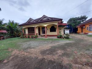 a house with a large yard in front of it at Rumah Teratak Bonda in Jertih