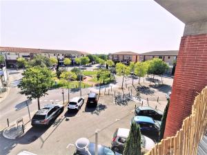 a parking lot with cars parked in a parking lot at T2 Cosy ₪ Residence Securise ₪ Airbus ₪ Piscine in Colomiers