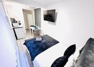 a bedroom with a bed with black pillows on it at Central studios in top location in London