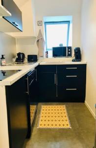 a kitchen with a sink and a counter top at Appartement avec parking et balcon vue Cathédrale in Chartres
