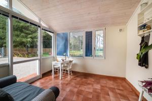 a living room with a table and windows at White Rooms in Sabaudia