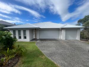 a large white house with a driveway at Upper Coomera Castle 1 in Gold Coast