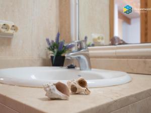 a bathroom sink with two dumplings on a counter at Apartamento Bonanza in Colonia Sant Jordi