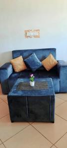 a blue couch with a table in a living room at Residence salam in Agadir