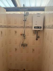a shower in a bathroom with a fan on the wall at Villa Samuel 