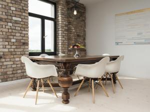 a dining room with a wooden table and white chairs at Riga Luxury Loft with Terrace in Rīga